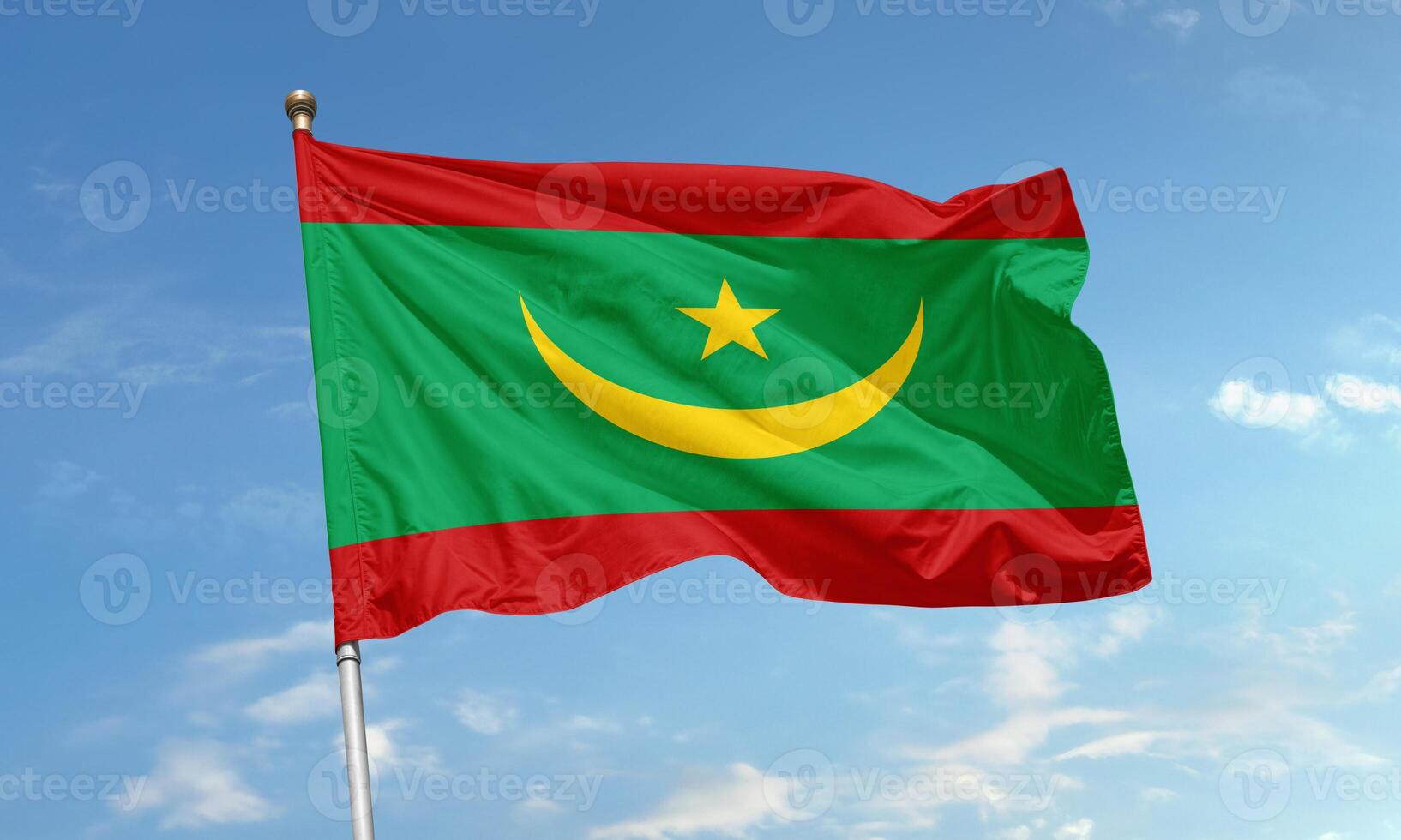 Waving flag of Mauritania with crescent and star on green, red and yellow background photo