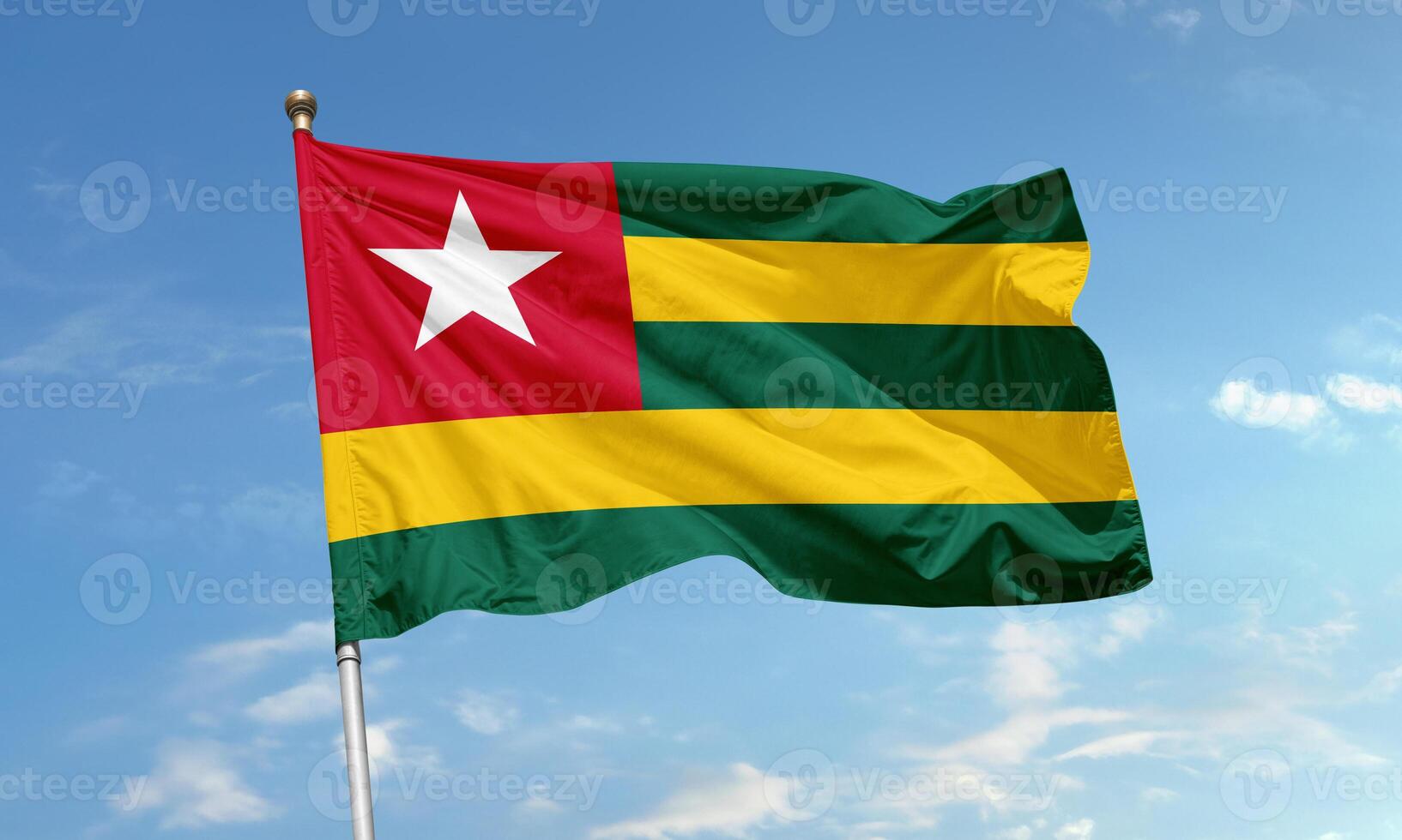 Togo national flag waving in blue sky photo