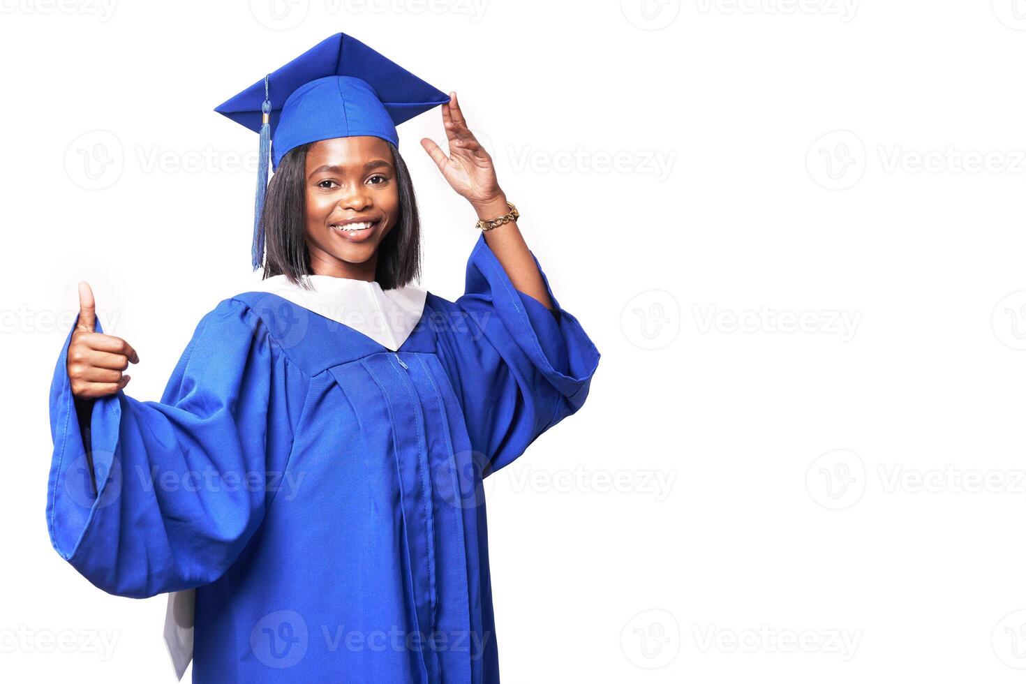 Black woman in a blue robe on a white background smiles and shows thumb up photo