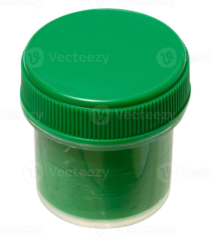 Plastic jar with green gouache paint, closed with green lid, isolated on background. photo
