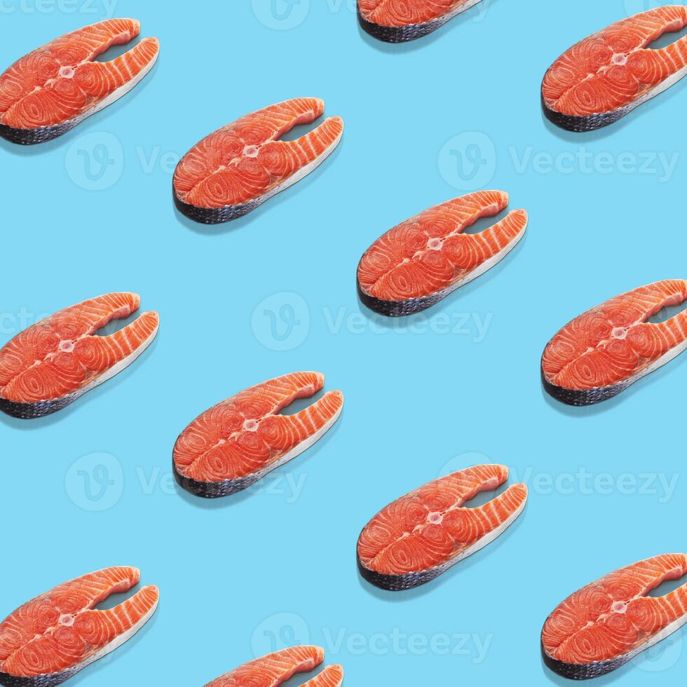 Piece of a salmon on blue background. Top view. Pop art design. photo