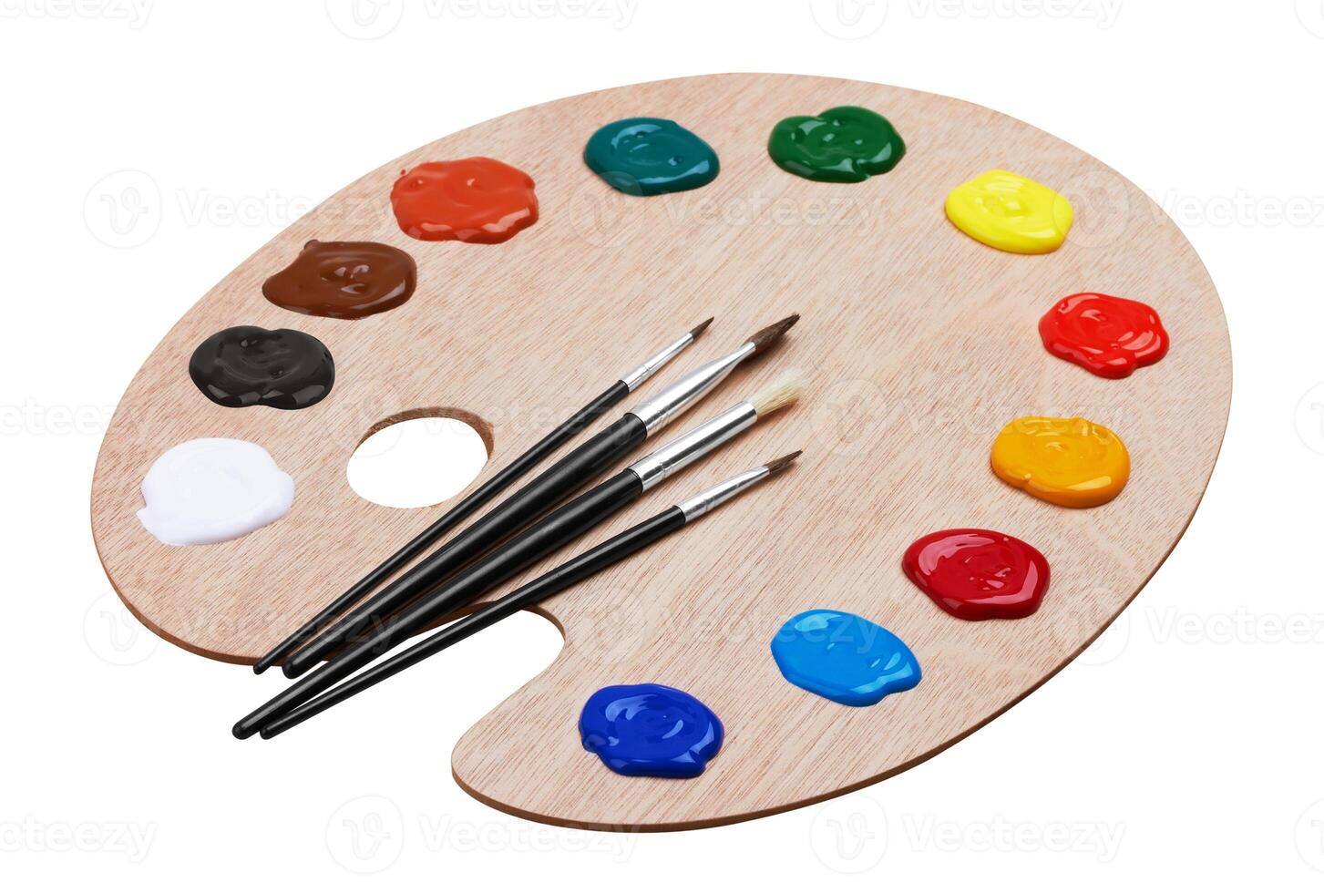Wooden art palette with paints and brushes photo