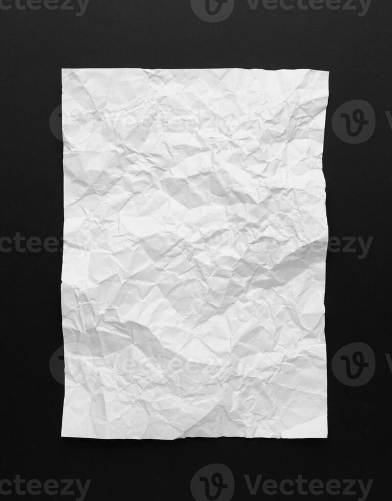 Top view of wrinkled paper texture on black photo