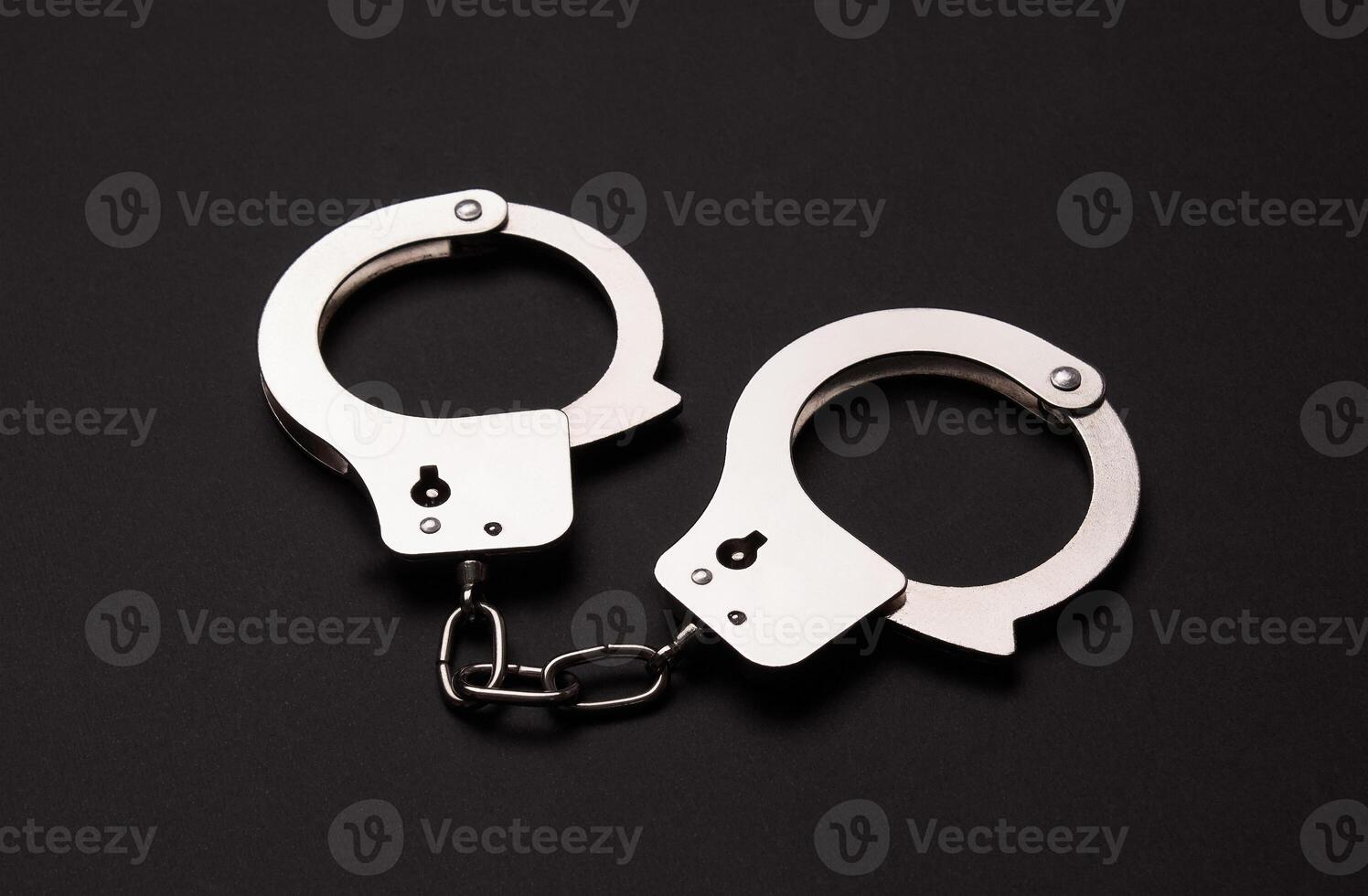 Handcuffs on a black background photo