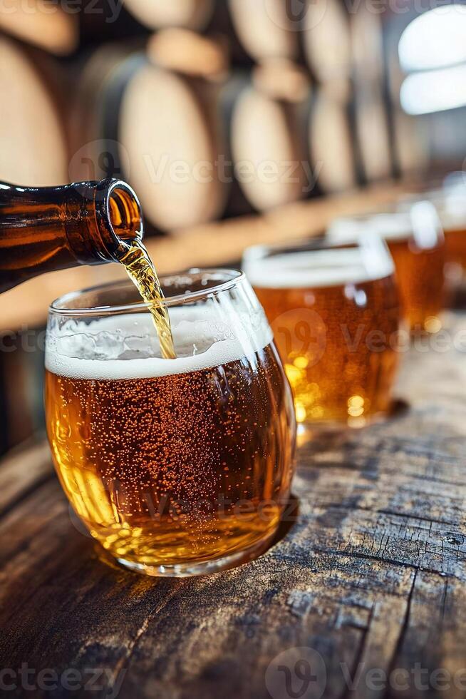 Craft beer pouring into glasses in rustic brewery setting with barrels. photo