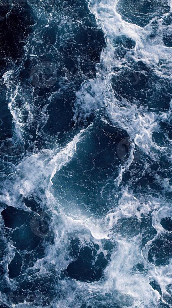 Dynamic ocean waves with white foam in deep blue sea close up. photo