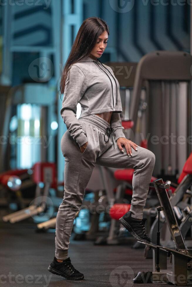 Fitness enthusiast exercises with determination inside a modern gym focused on strength training photo