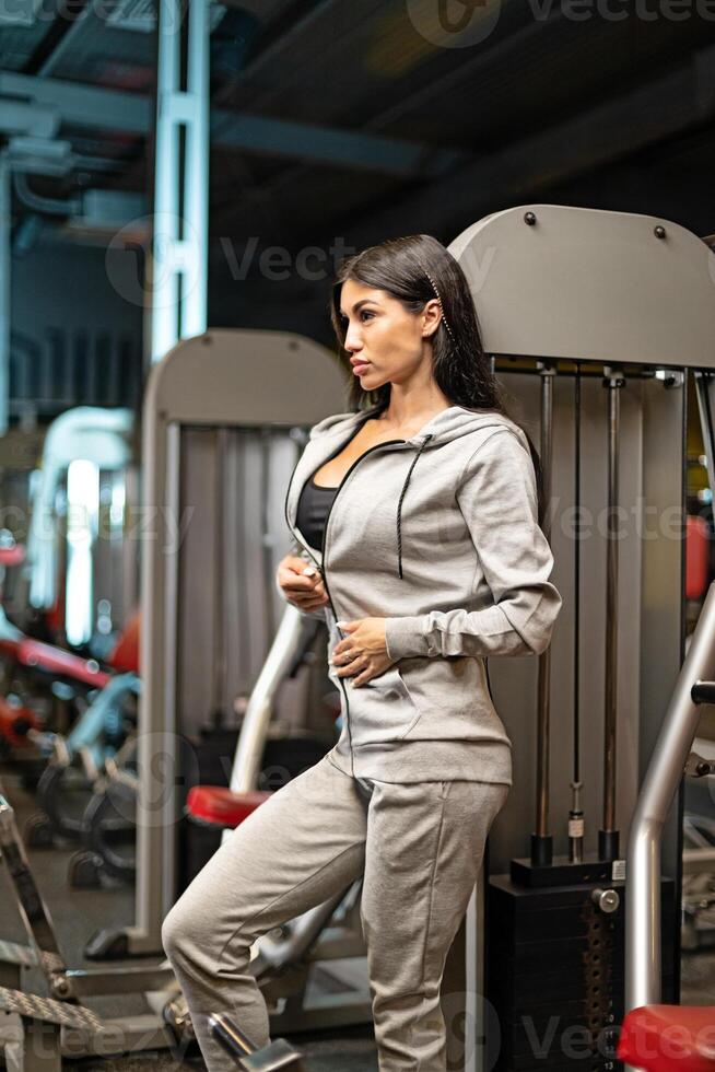 Fitness enthusiast taking a break during strength training in a modern gym environment photo