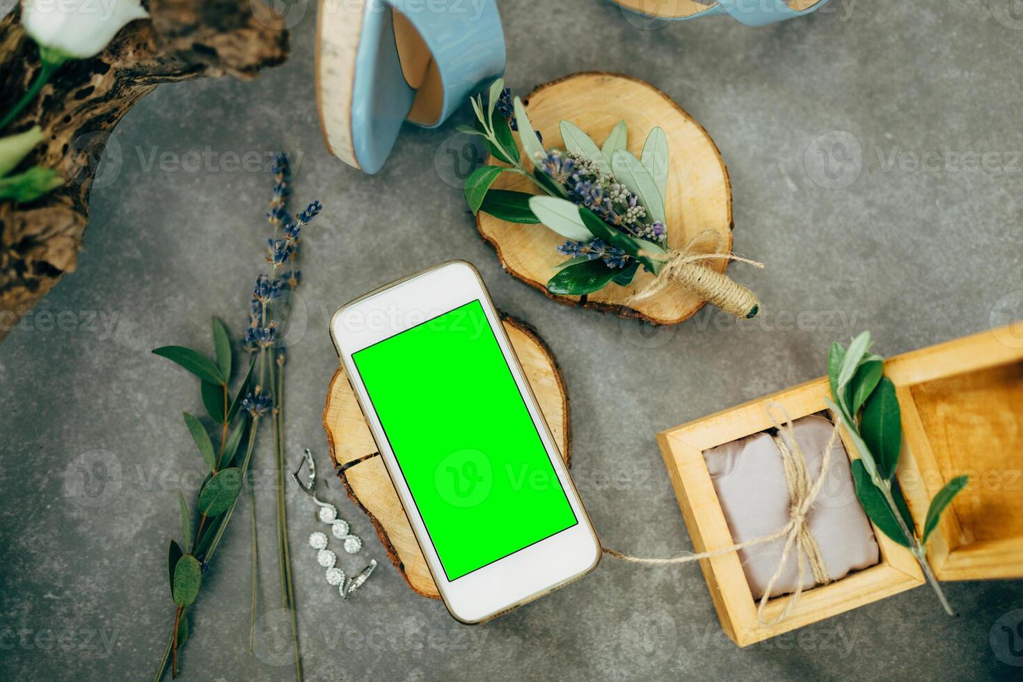 Mobile Phone on Wooden Slice Surrounded by Nature Elements photo