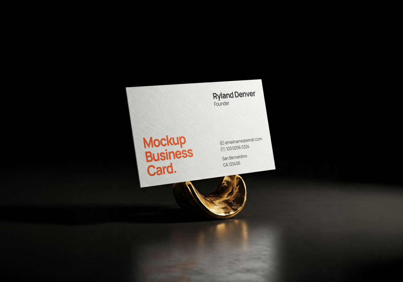 Elegant white business card mockup displayed on a golden holder over a reflective black surface in dramatic lighting psd