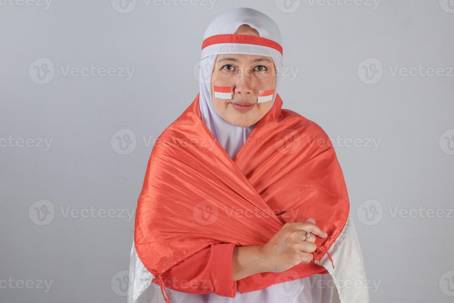Serious Indonesian woman wrapped in flag showing national unity and pride photo