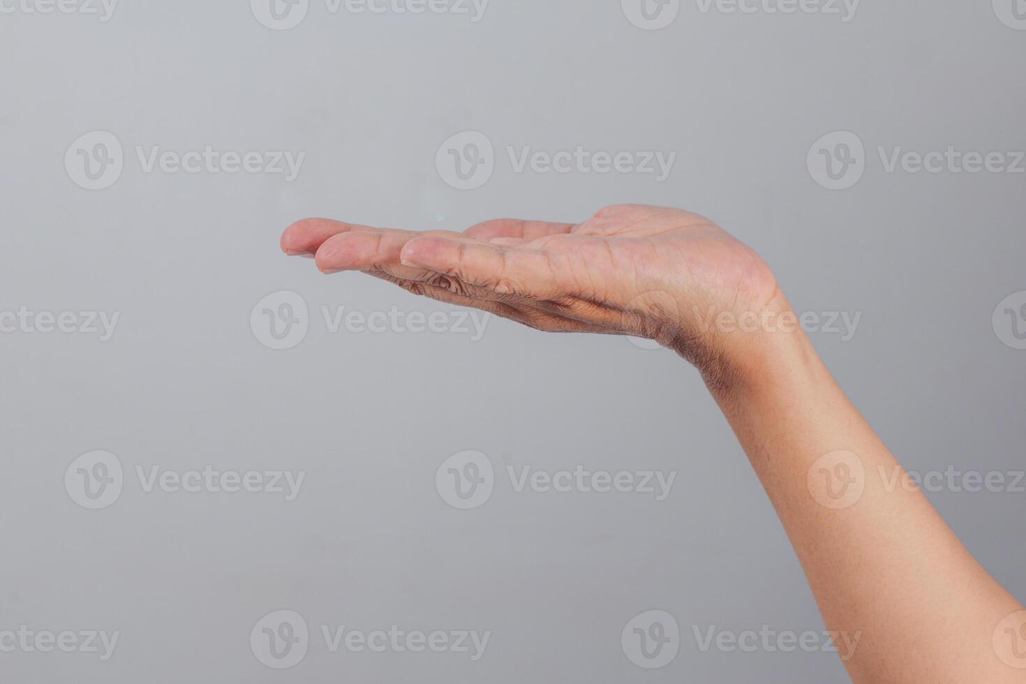 Outstretched human hand facing upward in horizontal position suggesting receiving, offering, or supporting action with fingers extended naturally on clean background photo