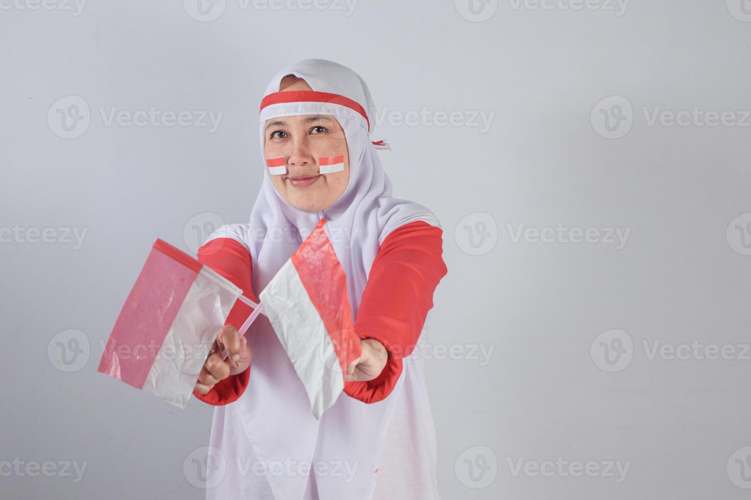 Indonesian Independence Celebration Spirit with patriotic expression holding flags, perfect for August 17 moments, national pride events, and cultural diversity themes photo