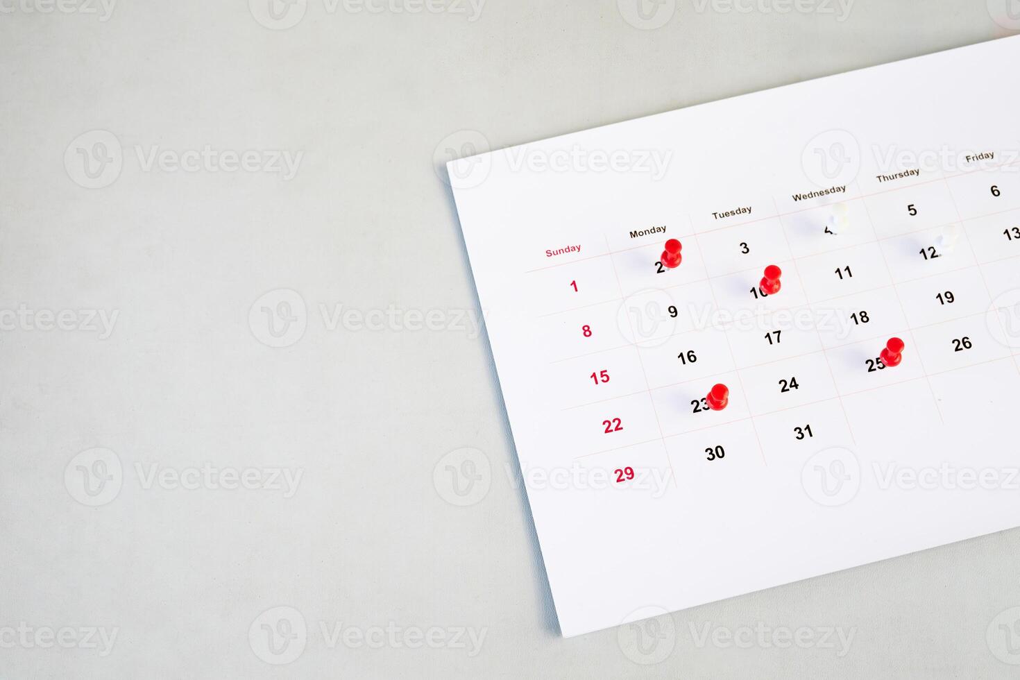 desk calendar with red pins photo
