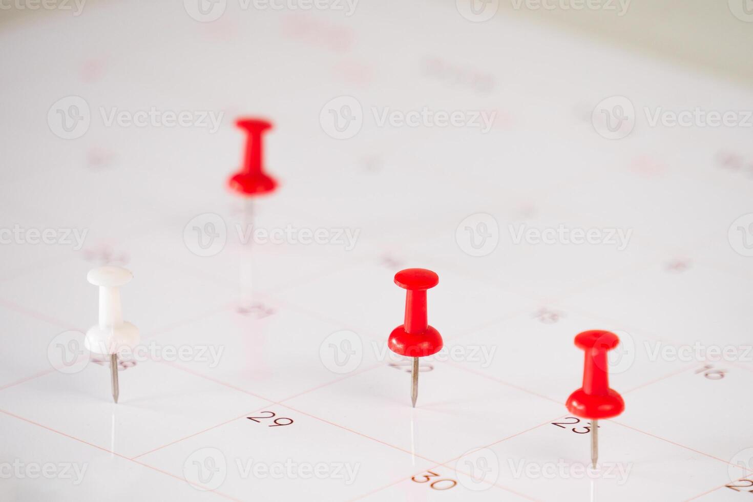 Calendar sheet with pin on table photo