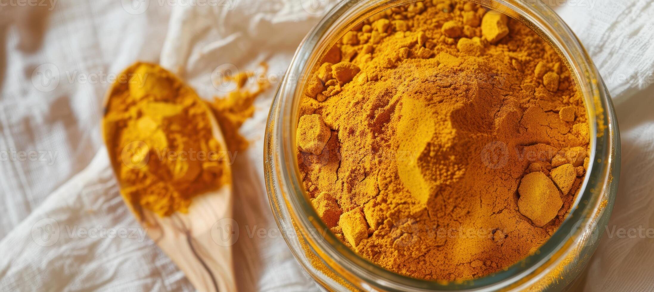 Culinary Spice Delight. Close-Up of Vibrant Turmeric Powder in Glass Jar for Kitchen Decor photo