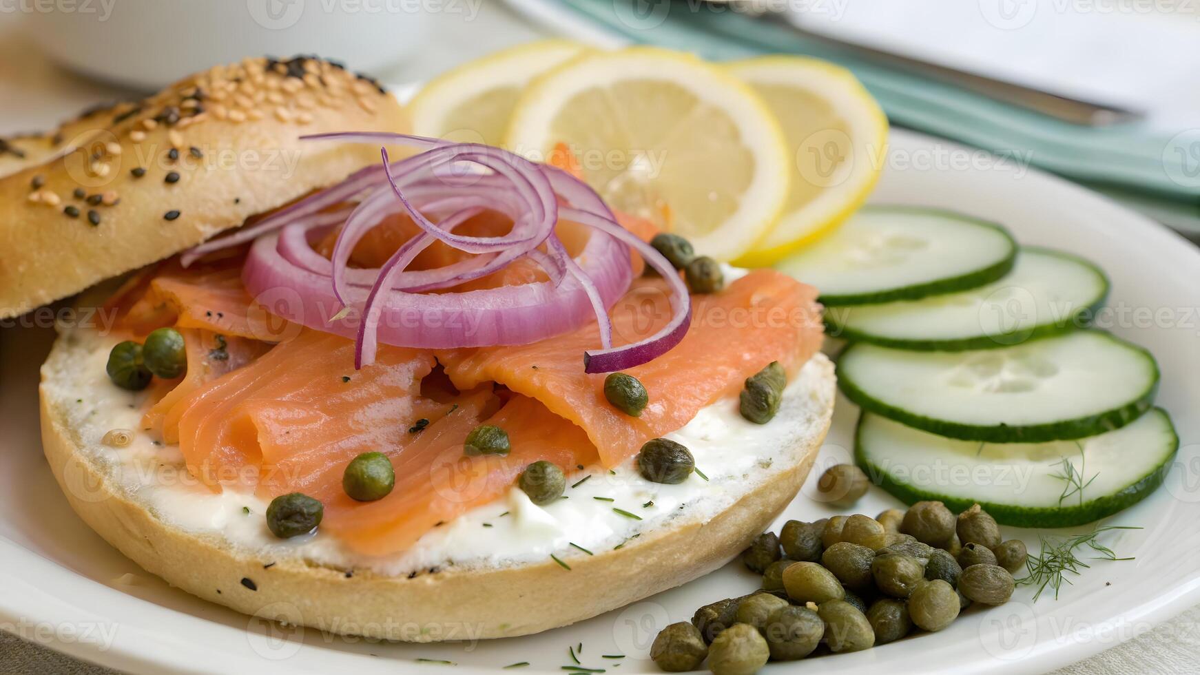 Salmon Lox Bagel Sandwich with Cream Cheese, Capers, and Red Onion on Plate photo