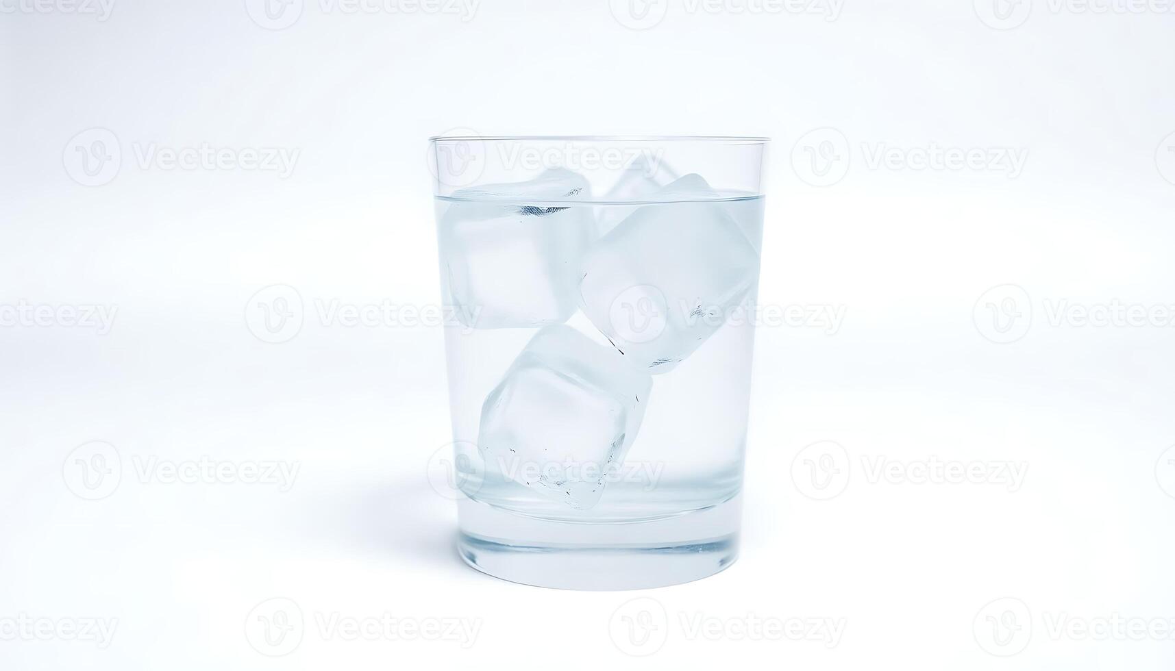 glass filled with ice on top of a white table photo