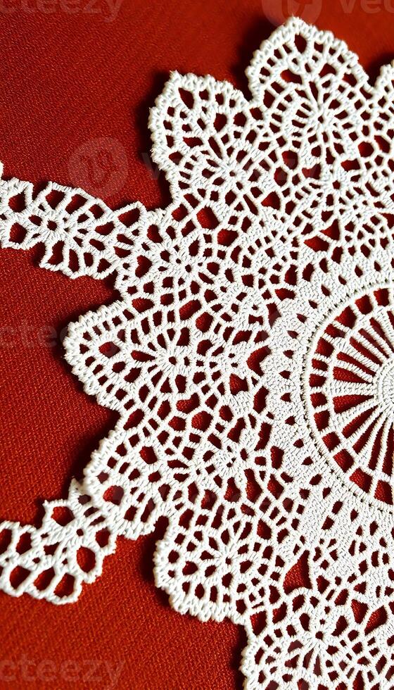 close up of a doily on a red surface photo