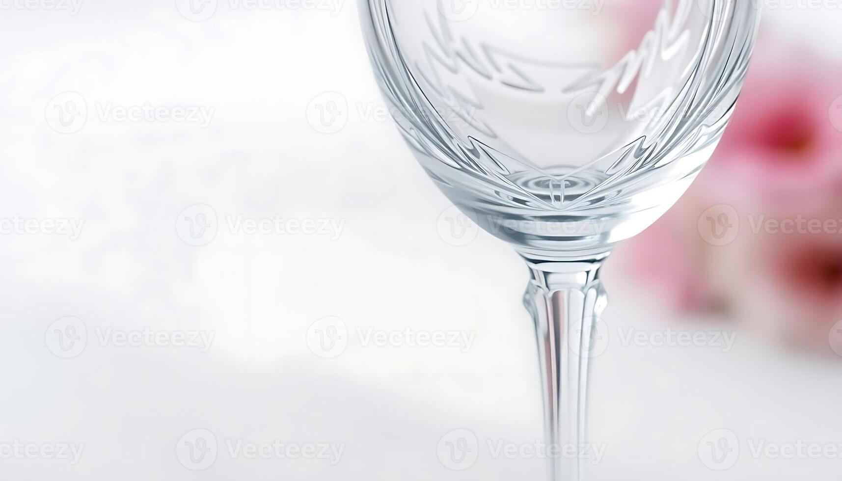 close up of a wine glass with a flower in the background photo