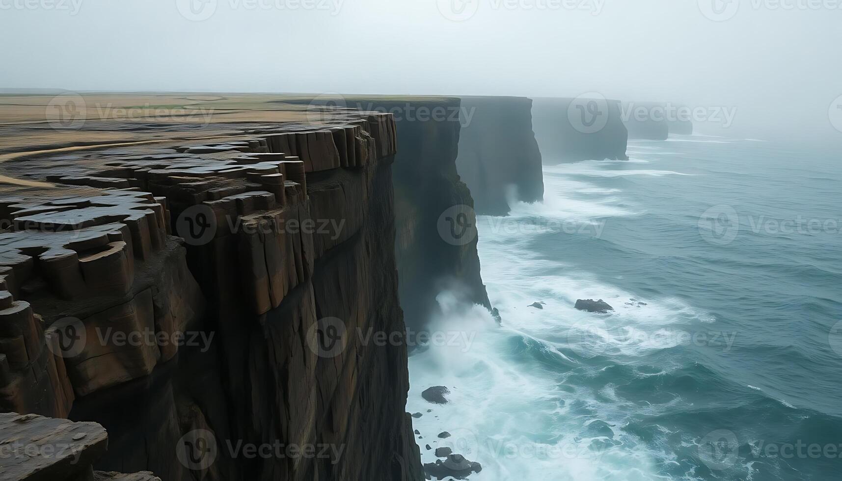 cliff with a large body of water next to it photo