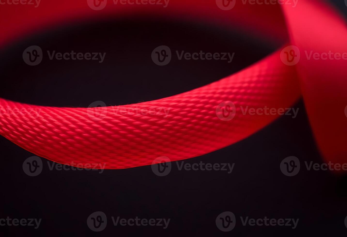 close up of a red ribbon on a black background photo
