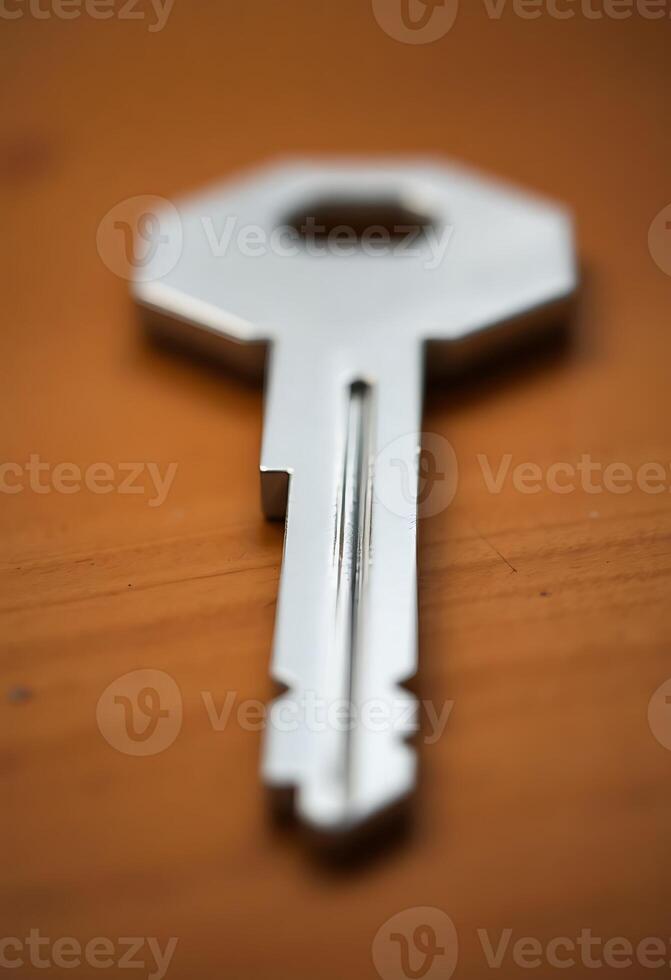 close up of a key on a wooden surface photo
