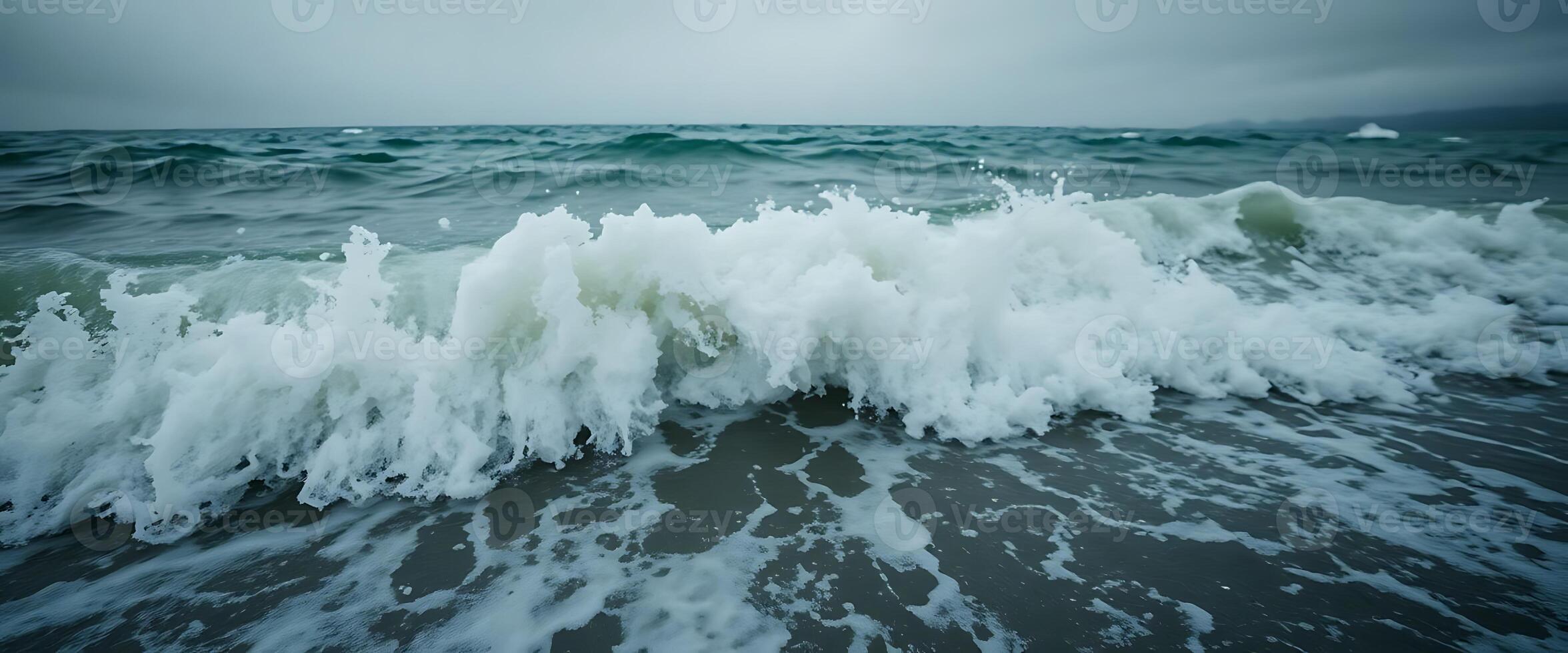 large body of water with waves crashing on it photo