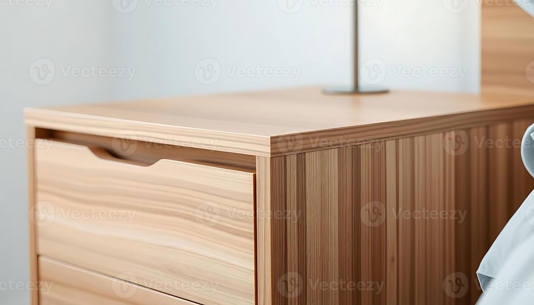 close up of a bed with a wooden dresser photo