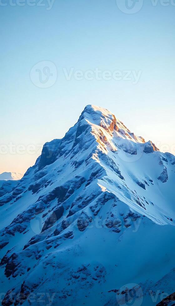 large mountain covered in snow under a blue sky photo