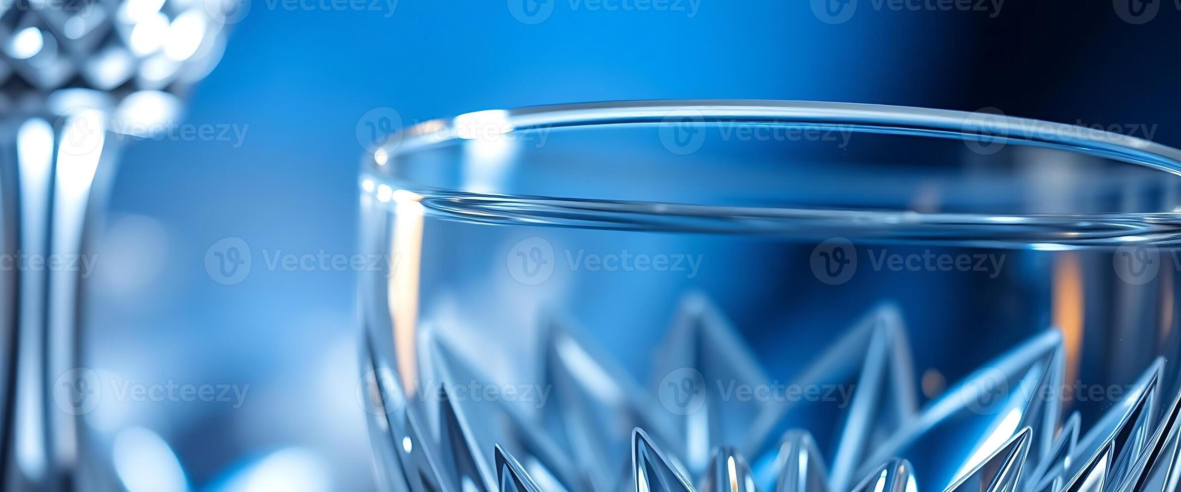 A close up of two glasses with a blue background photo