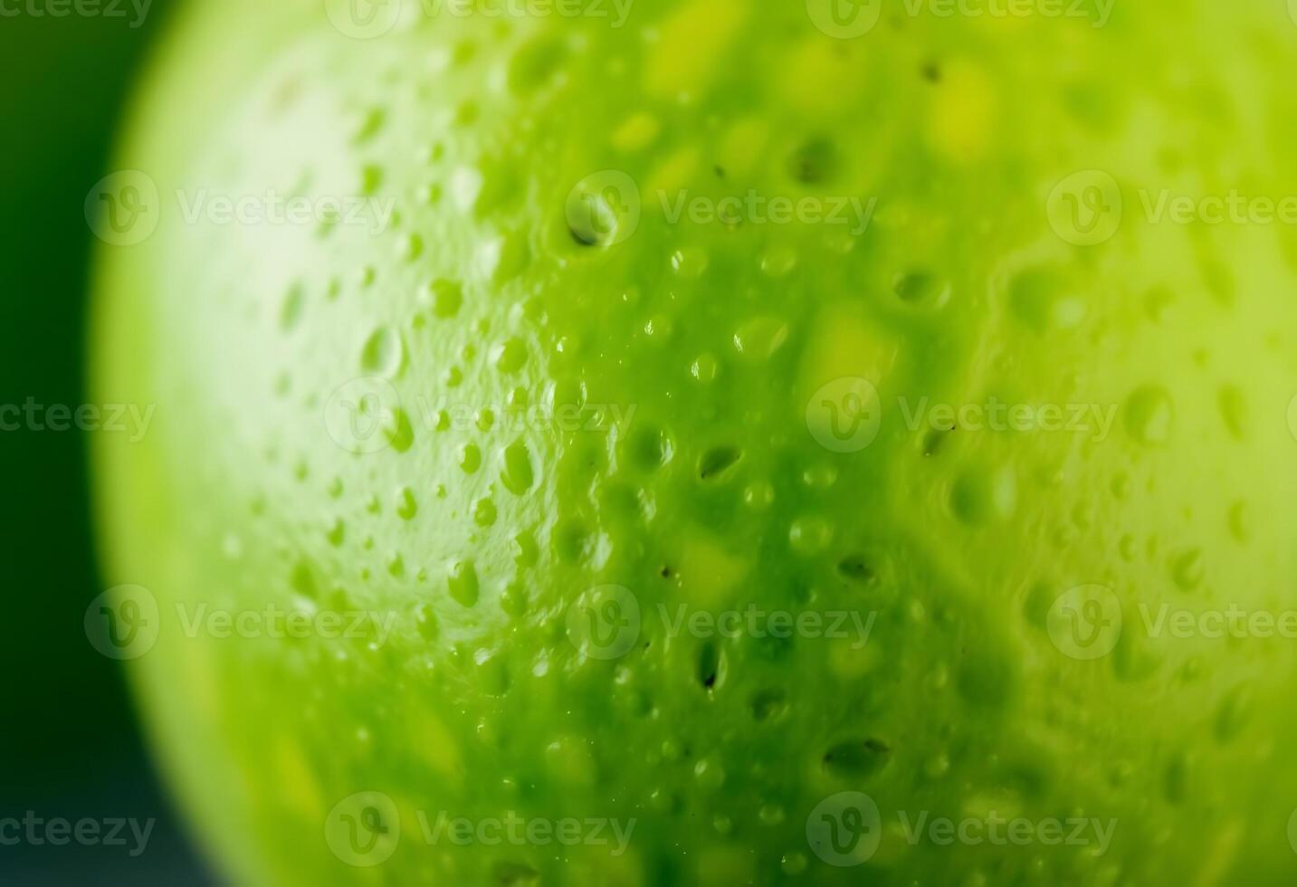 close up of a green apple with water drops photo
