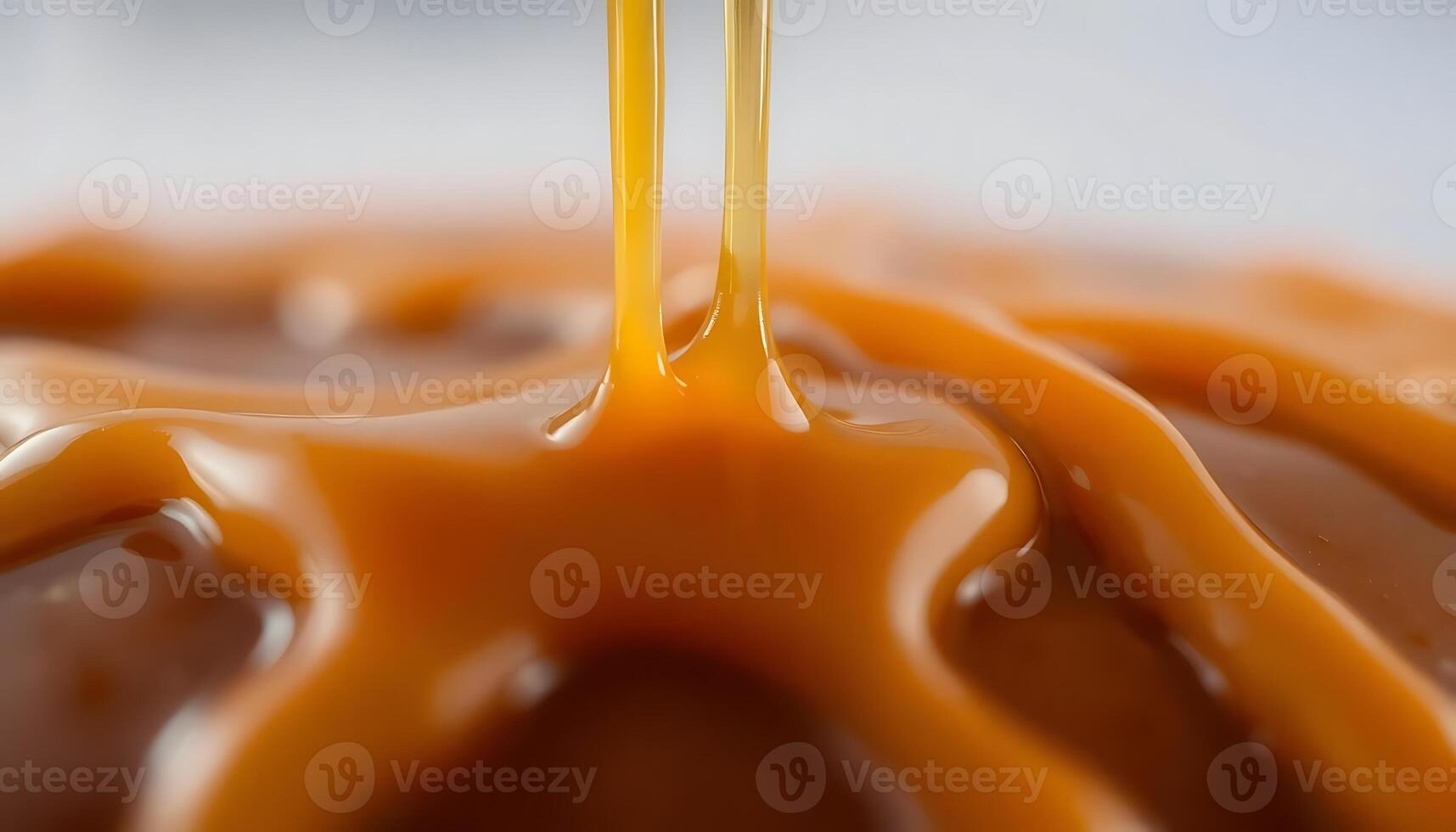 close up of caramel sauce being drizzled over photo