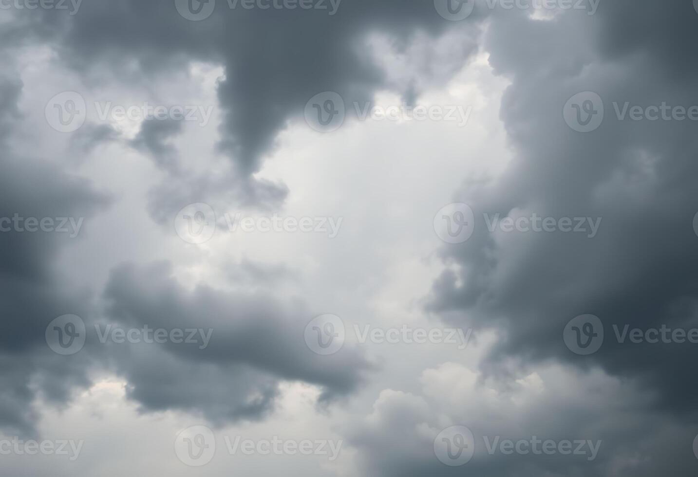 A dark cloudy sky with some white clouds photo