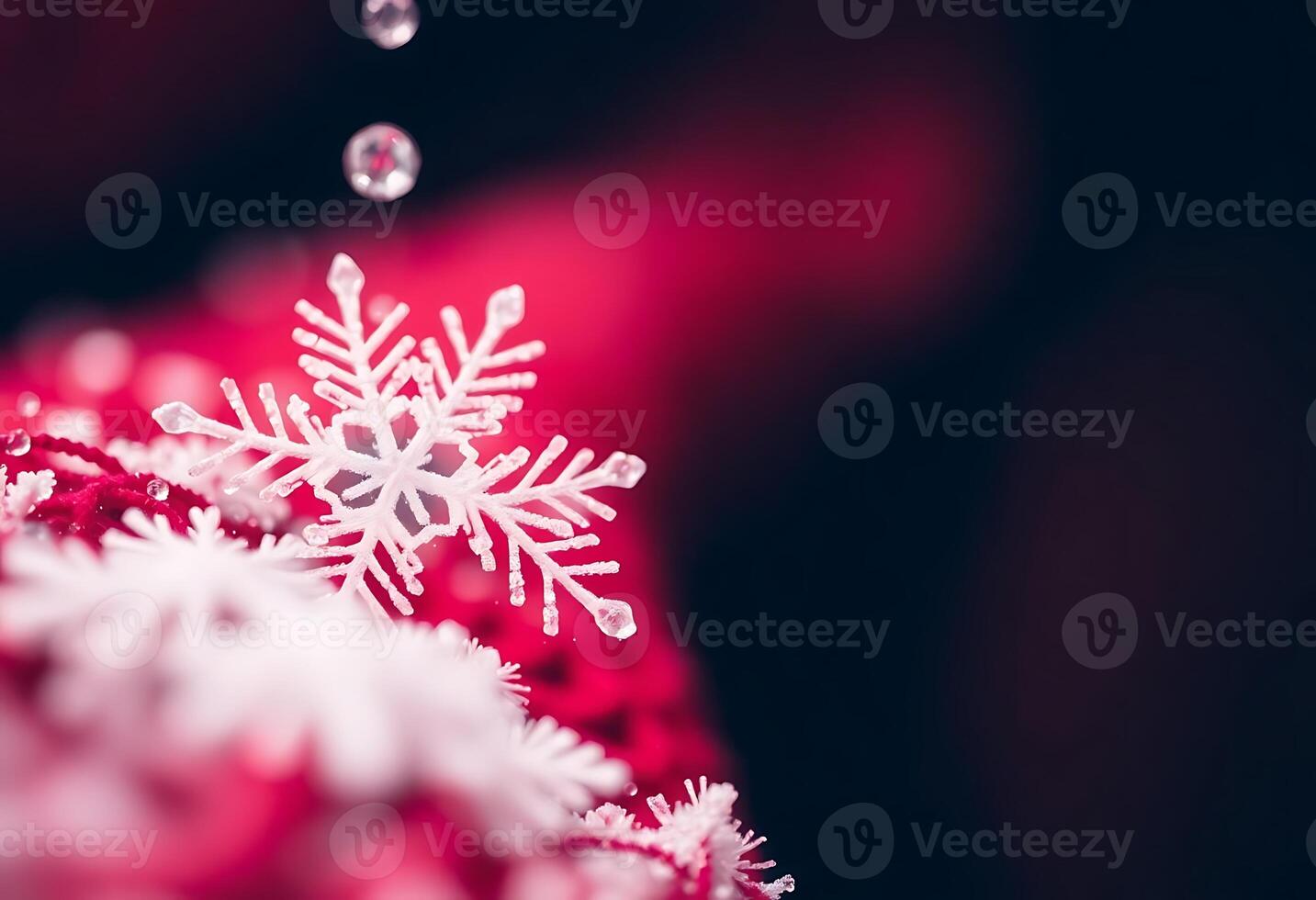 A snowflake is hanging from a red ribbon photo