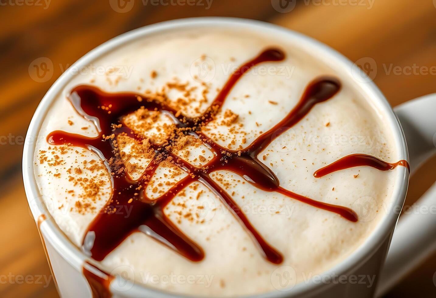 A white cup with a latte and caramel drizzle photo