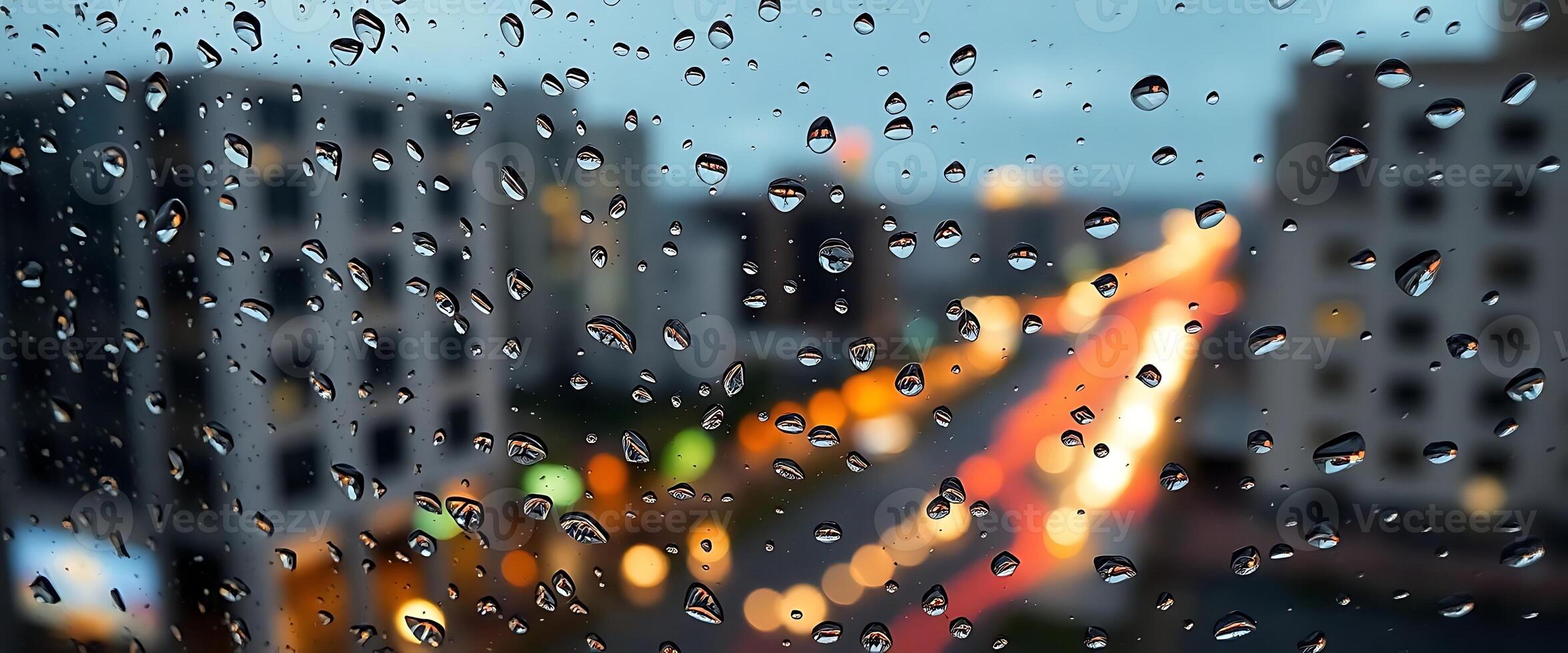 Rainy city view through a window with water droplets on it photo