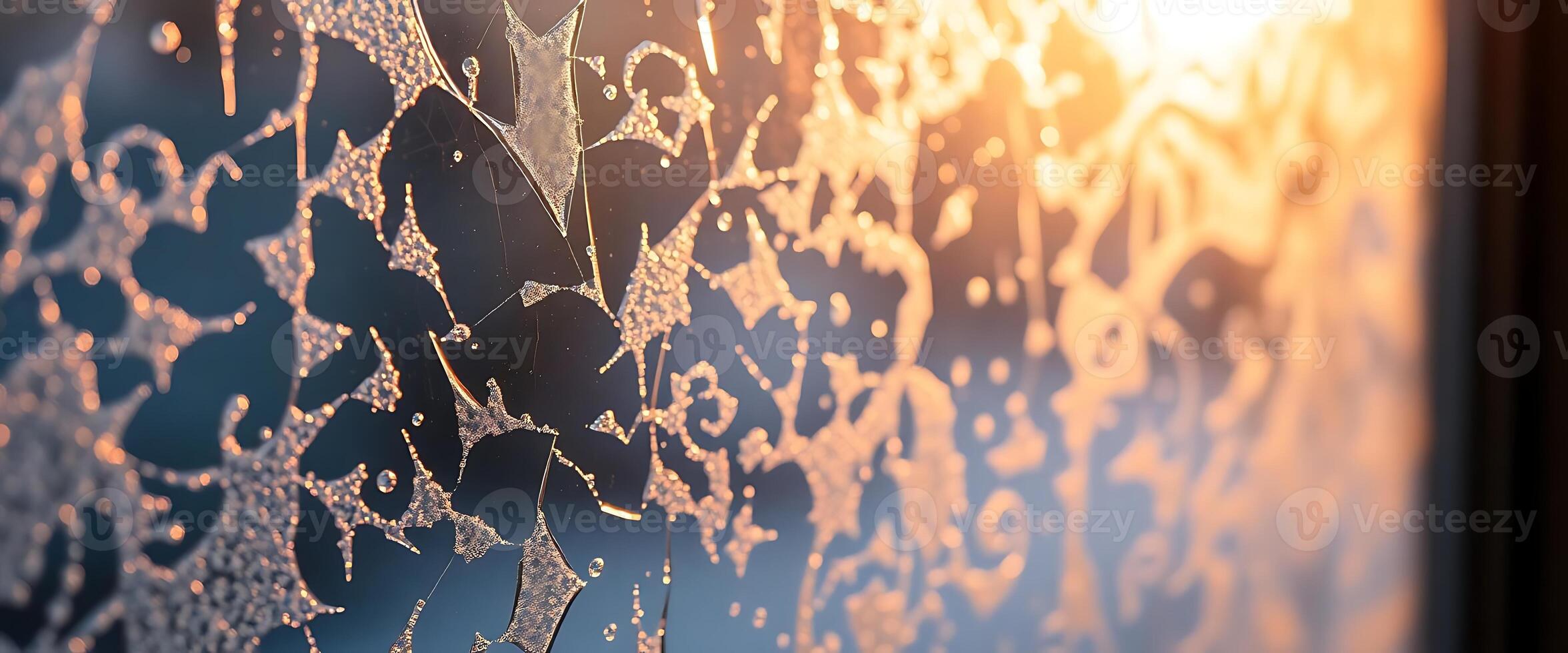 A frosty window with a sunset in the background photo