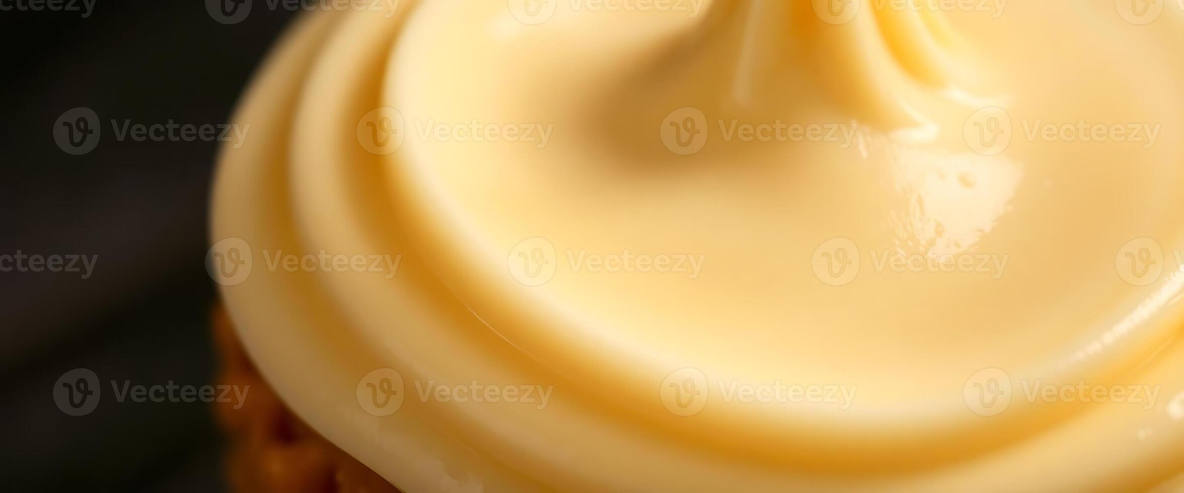 A close up of a cupcake with yellow frosting photo