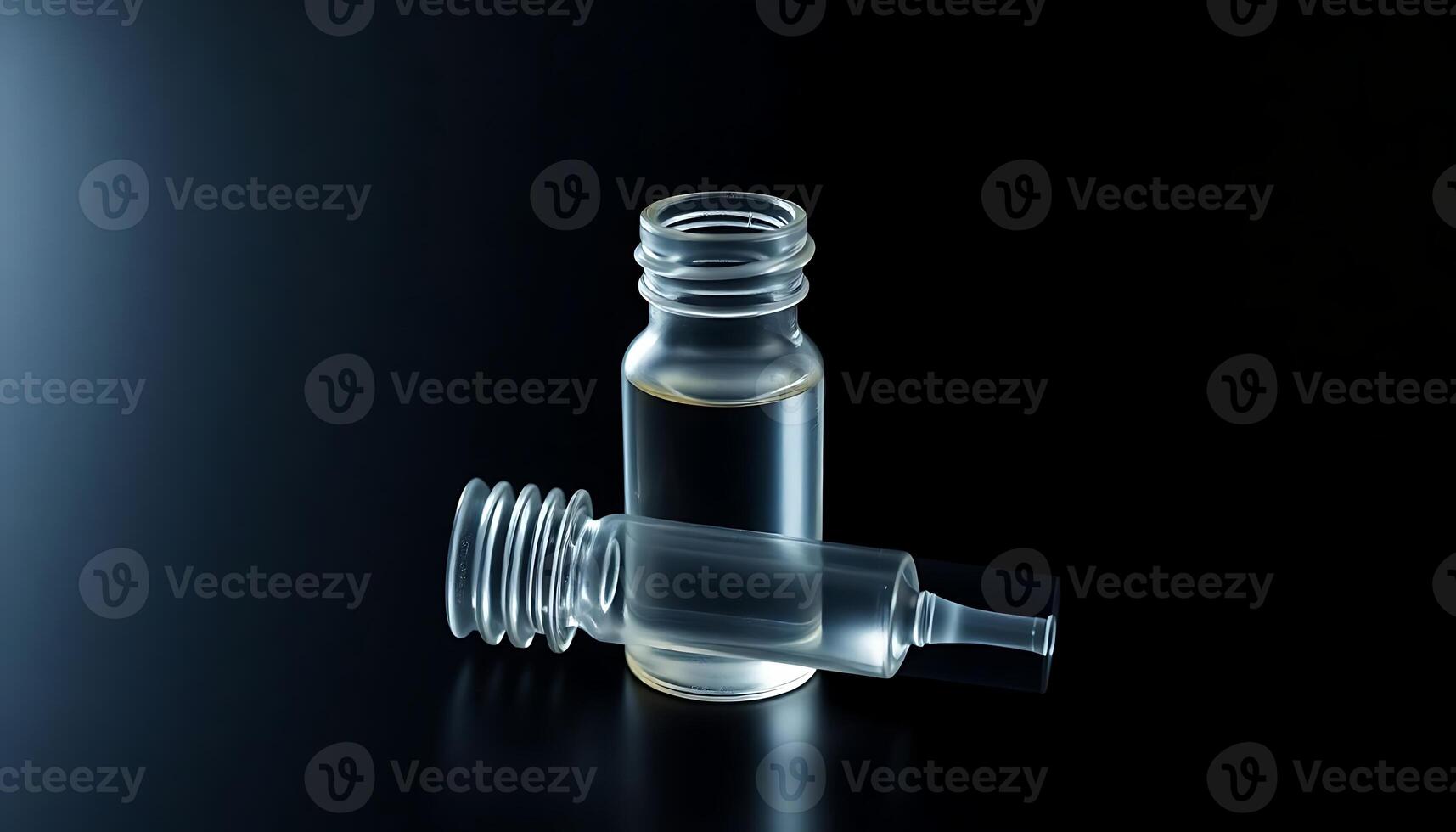 glass bottle with a dropper on a black surface photo