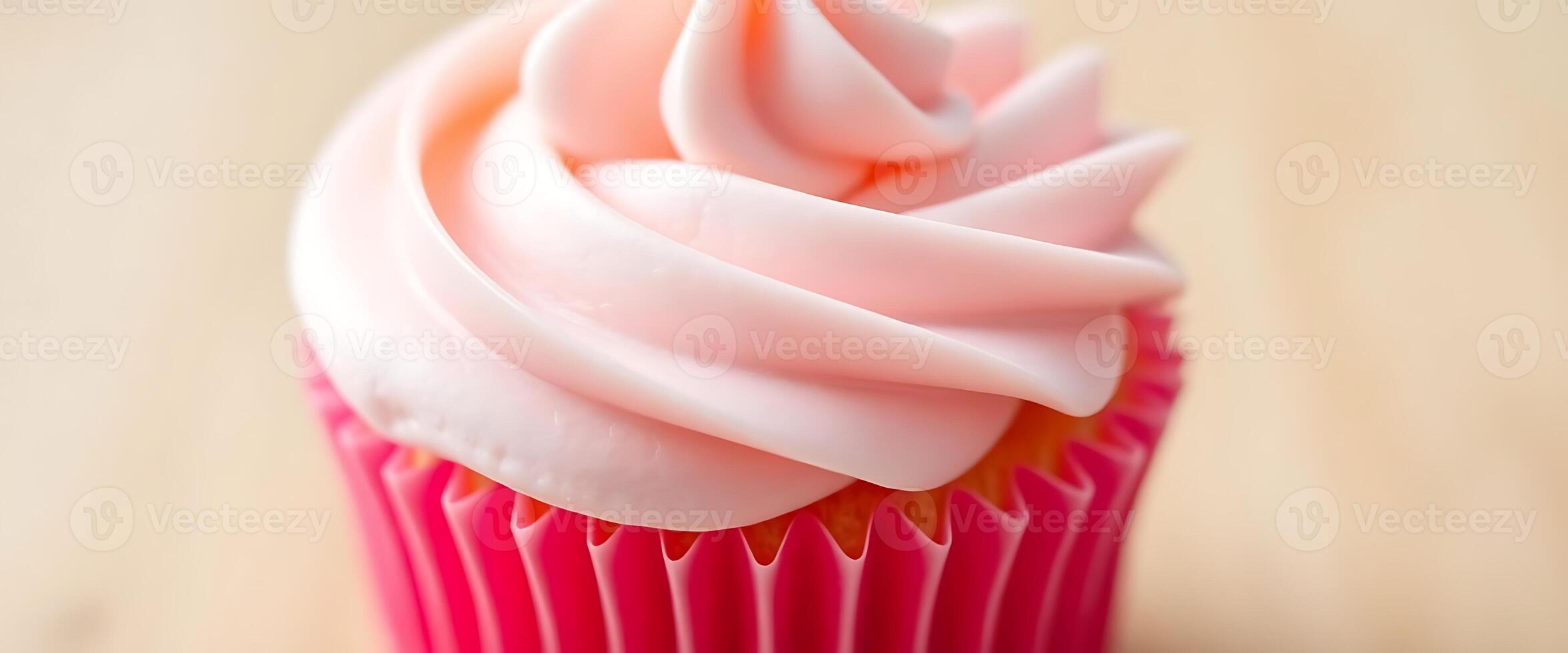 A cupcake with pink frosting on top photo