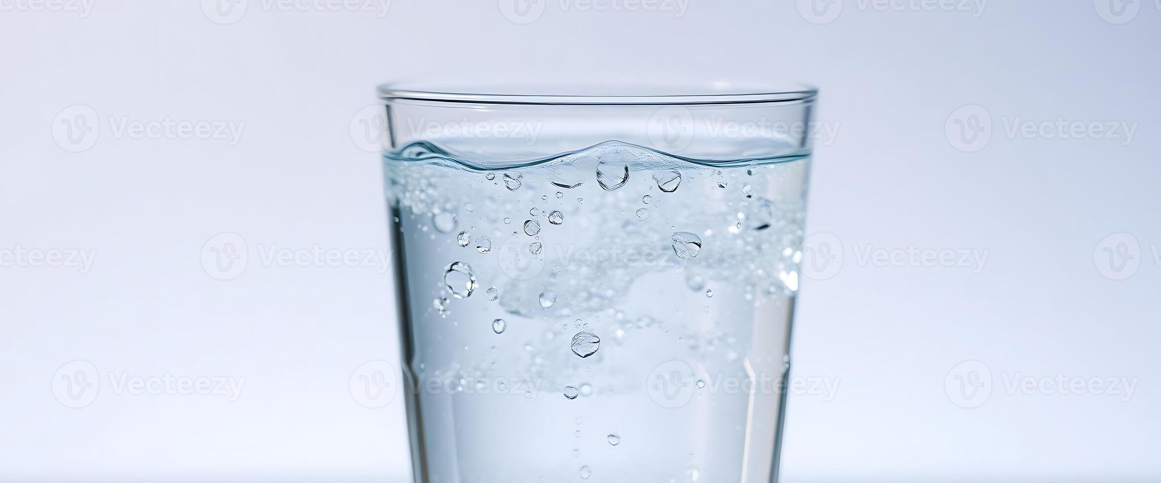glass filled with water on top of a table photo