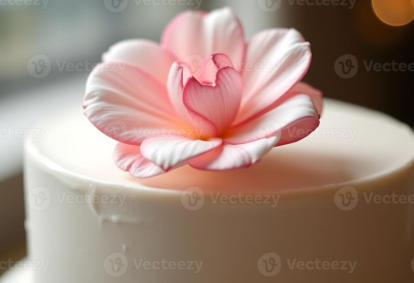 white cake with a pink flower on top photo
