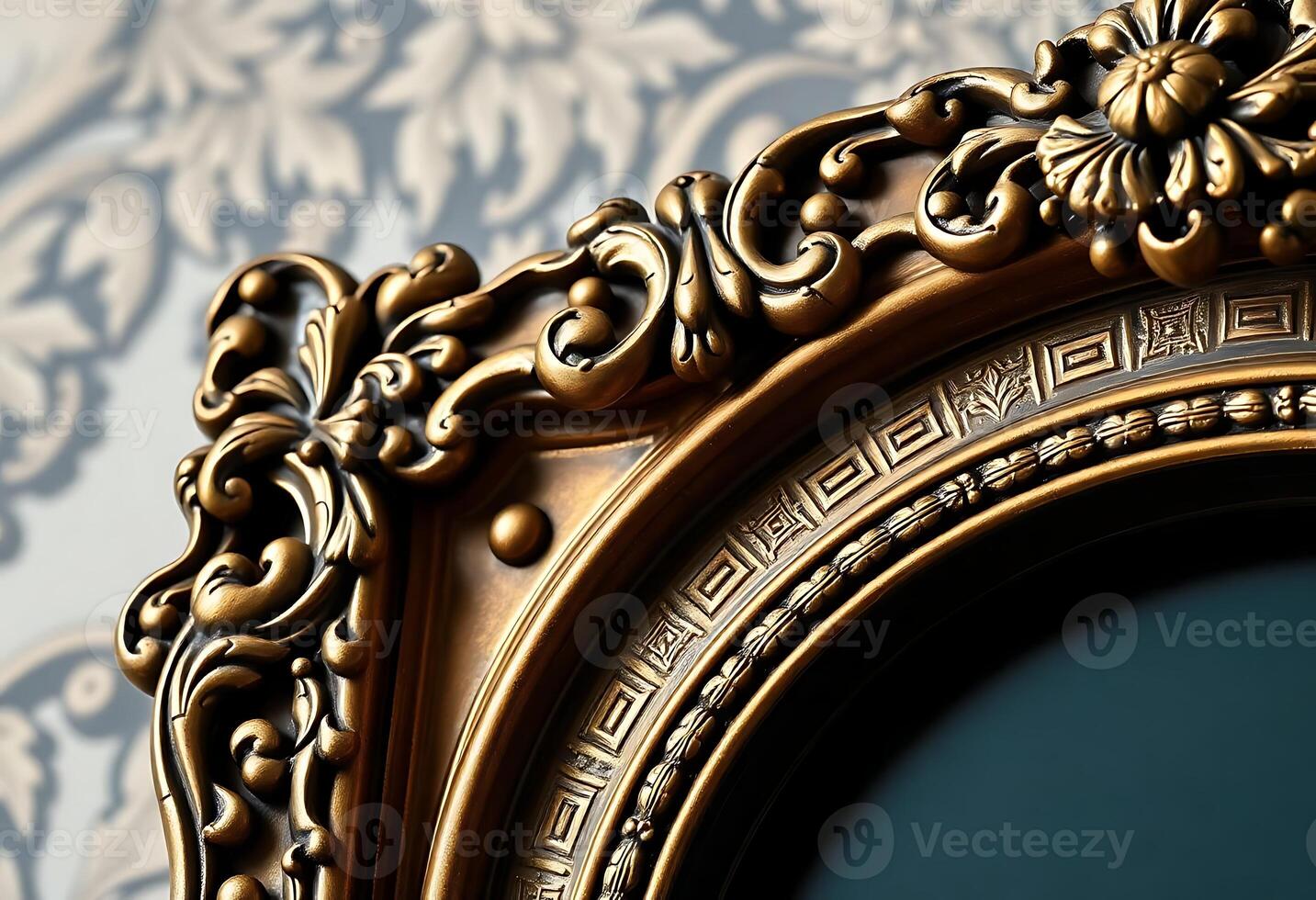 close up of a gold framed mirror on a wall photo