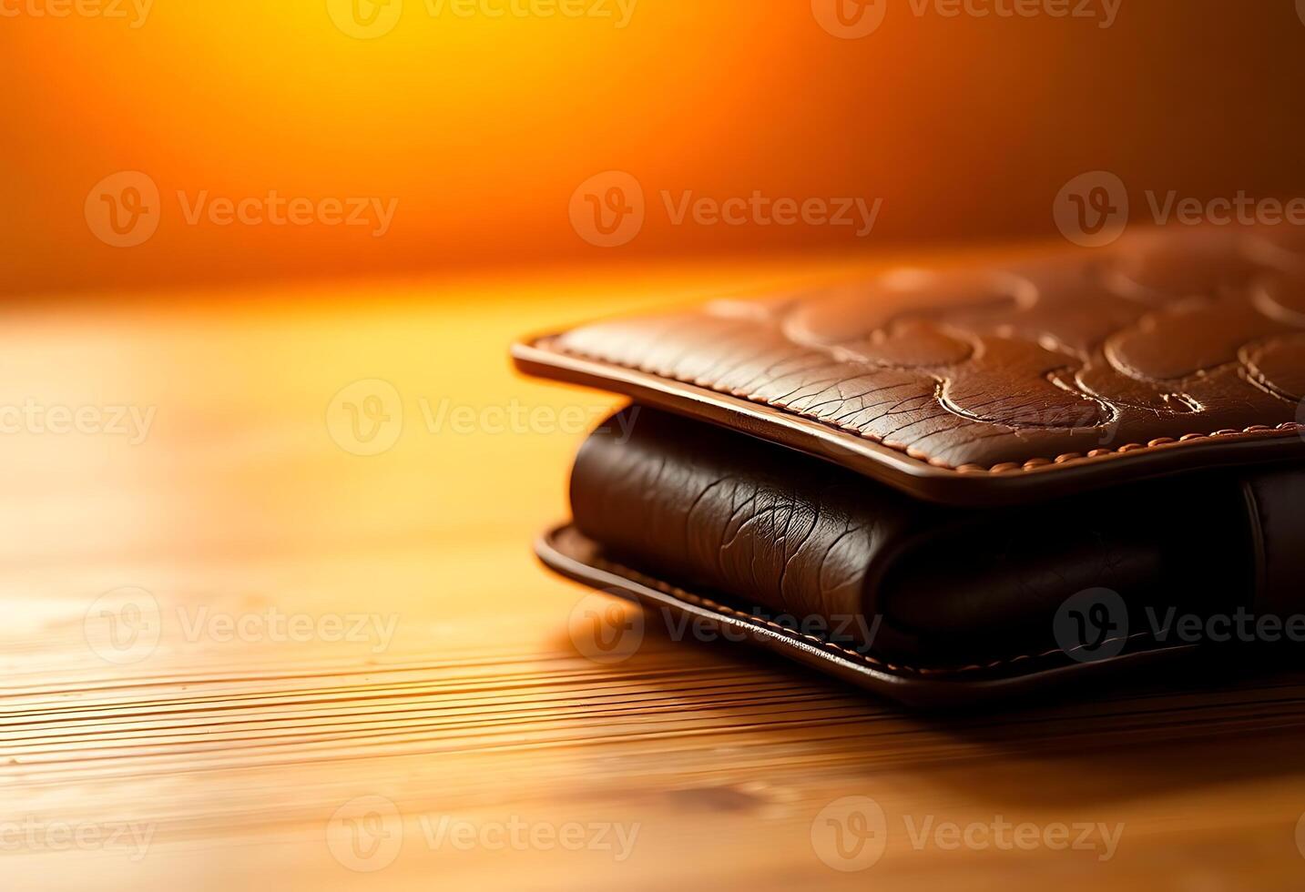A leather wallet sitting on a wooden table photo