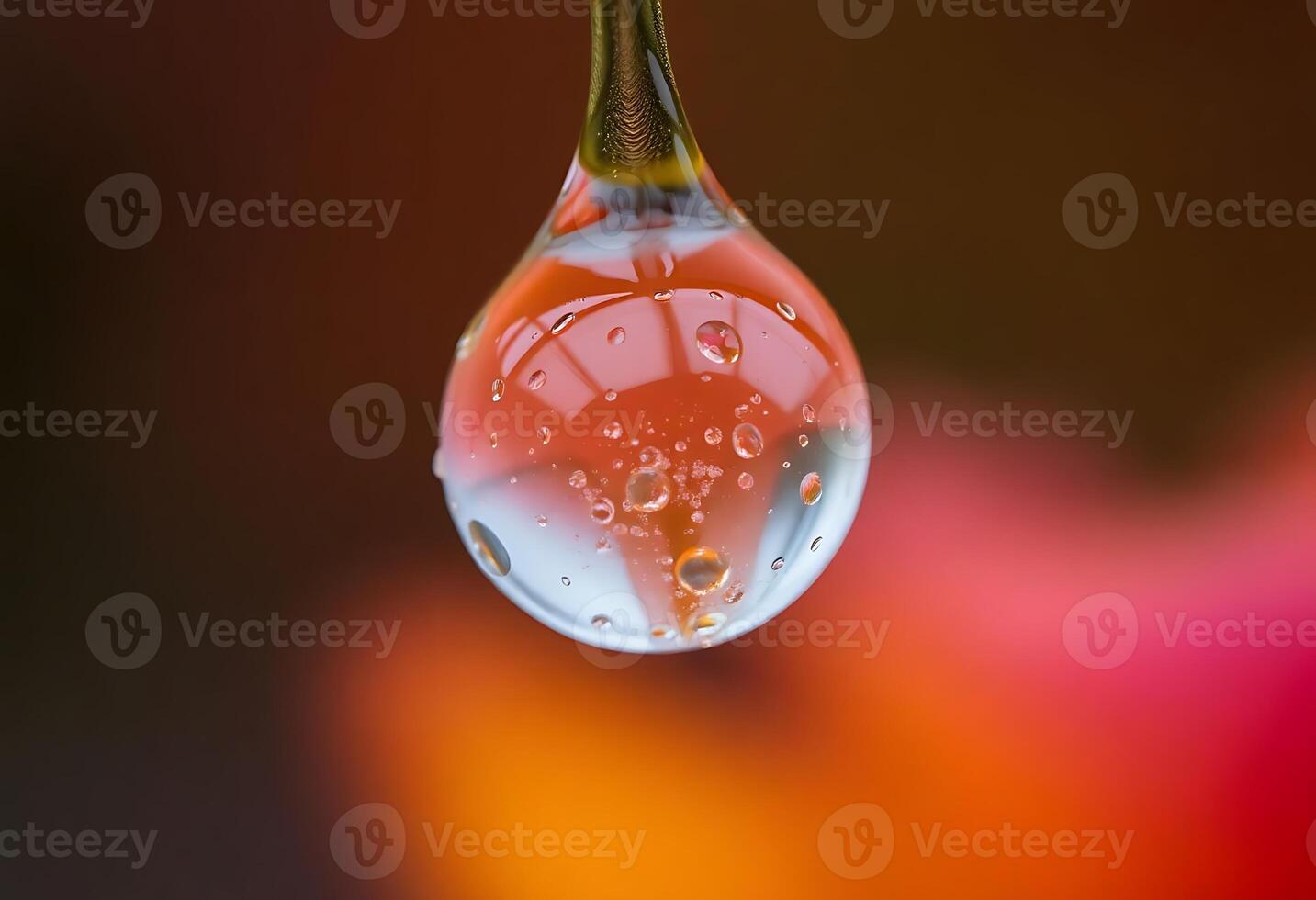 A drop of water hangs from a string photo