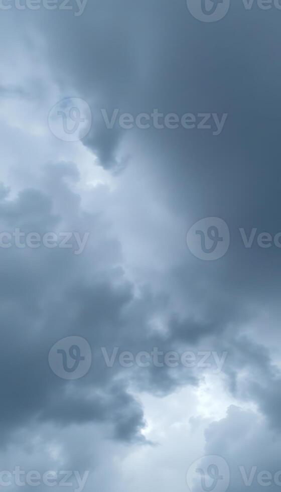 A plane flying through the sky with dark clouds photo
