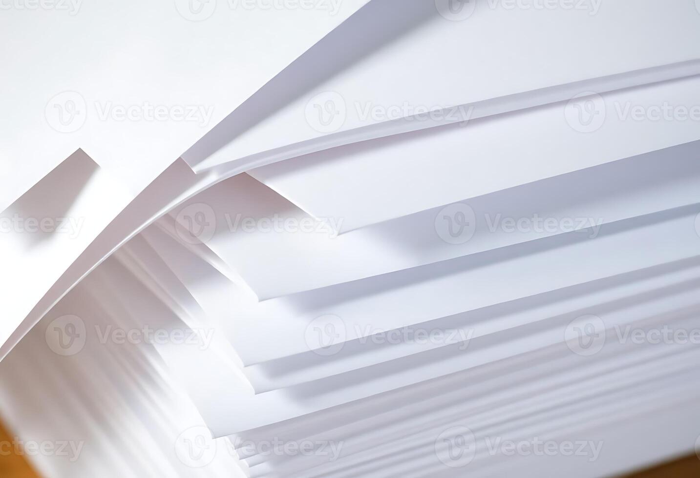 A stack of white paper on a wooden table photo
