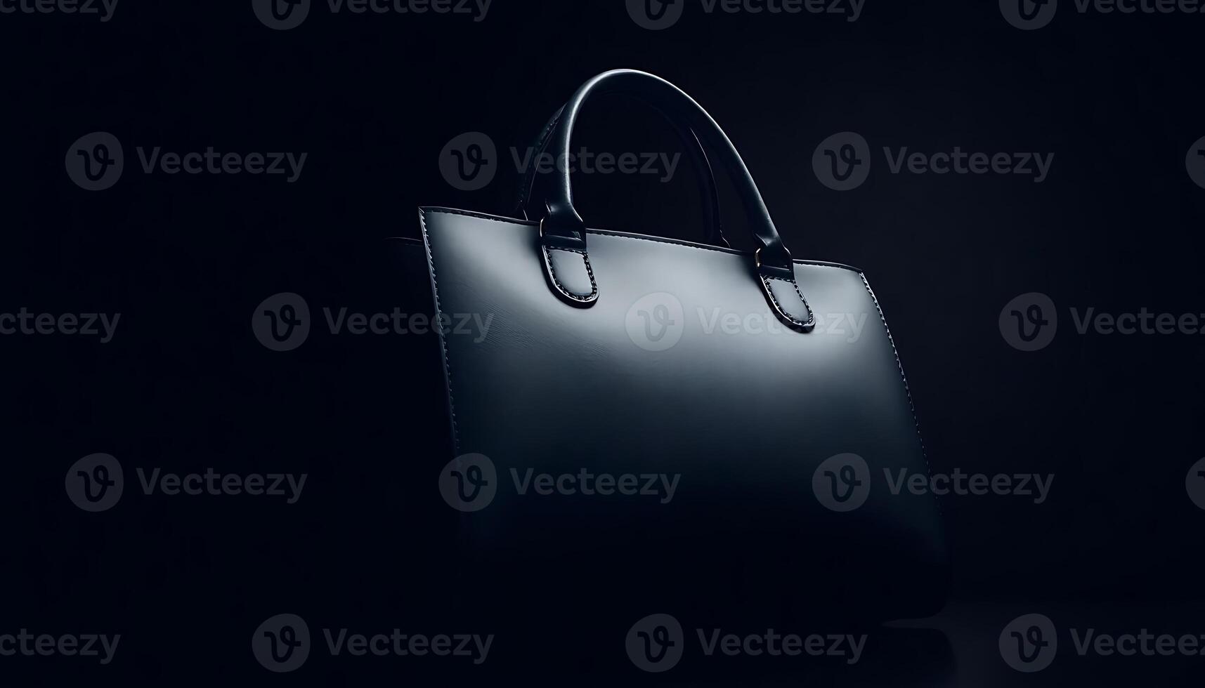 black handbag sitting on top of a table photo