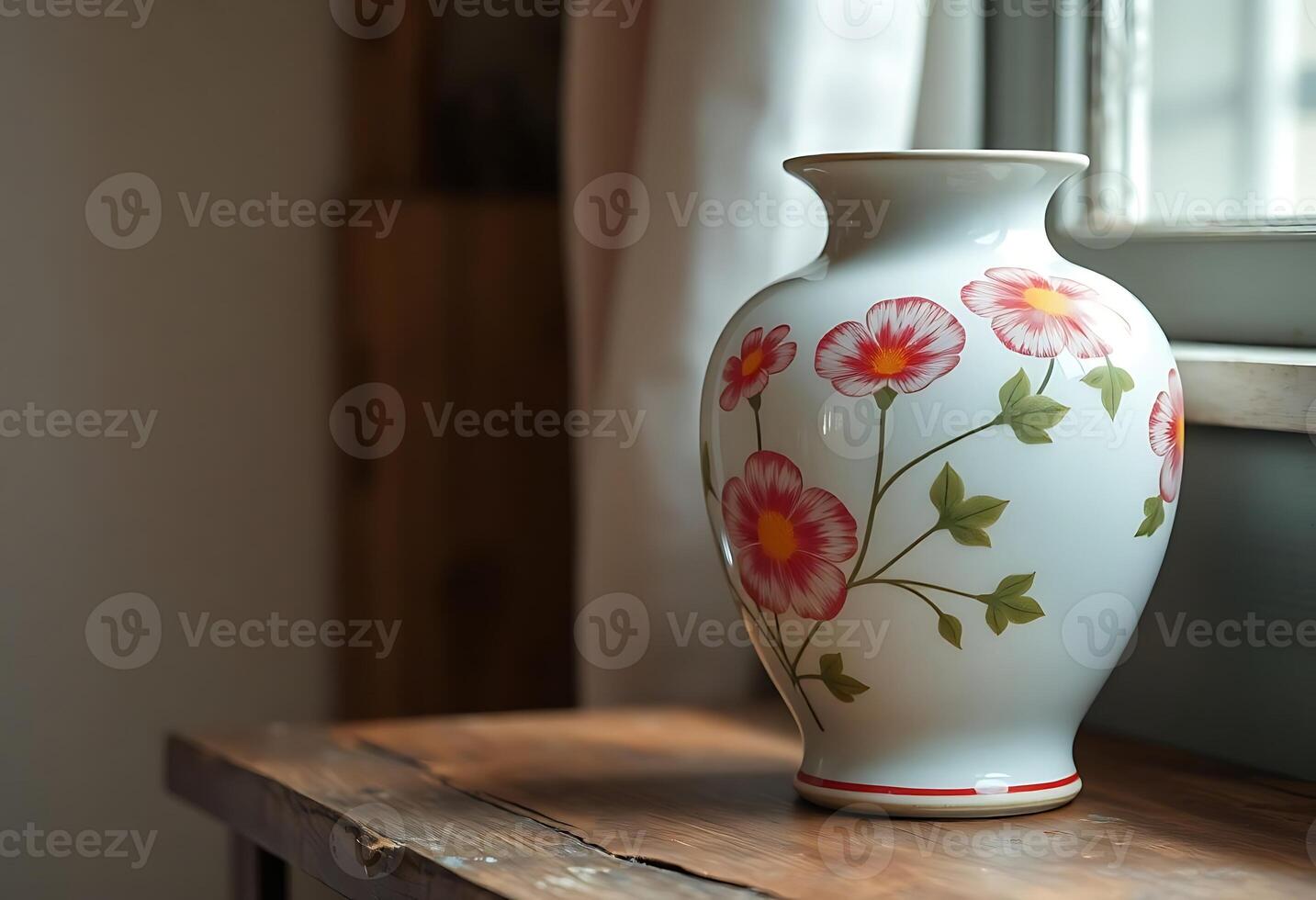 A vase with flowers on it is sitting on a table photo